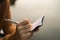 Woman hand writing down in small white memo notebook.