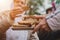 Woman handing out slices of brown bread to old people