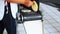 Woman handling fresh corn tortillas from tortilla making machine traditional mexican