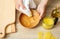 Woman hands apply homemade beeswax wood treatment polish to restore natural wood bowl color.
