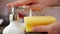 Woman hands apply washing liquid from dispenser on sponge