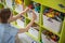 Woman hands applying sticker with name title of children toys for comfortable sorting and storage