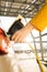 Woman hands attaching power cable supply to charge electric or EV car on the solar panels background. Female plugging an