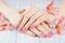 Woman hands with beautiful pink matted manicure