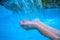 Woman hands in blue water. Fresh water current. Young girl hands in water flow.