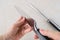 Woman hands checking the blade of professional chef knife after using the sharpening steel. Modern kitchen utensils made of high