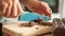 Woman hands chopping chocolate block for celebratory cake