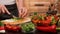 Woman hands chopping spring onions for a vegetables salad