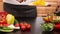 Woman hands chopping yellow pepper slices for a salad