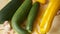 Woman hands cleaning the kitchen knife yellow zucchini