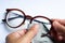 Woman hands cleaning shortsighted or nearsighted eyeglasses by microfibre cleaning cloths, On white background, Optical concept