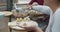 Woman hands closeup making Chinese food wonton with boyfriend and mother outdoor