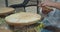 Woman hands closeup making Chinese food wonton outdoors with meat and dough