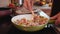 Woman hands cooking a delicious meal in frying pan - homemade food made of vegetable mix and ground meat