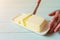 woman hands cutting butter on a lime wooden desk