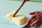 woman hands cutting butter on a lime wooden desk