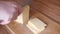 Woman hands cutting cheese on wooden board