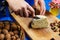 Woman hands cutting spicy homemade cheese on cutting board, serv