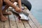 Woman hands cutting a tuna head on a wooden pier