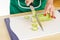 Woman hands cutting zucchini round slices