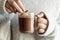 Woman hands dipping cookie in hot chocolate