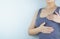 Woman hands doing breast self-exam for checking lumps and signs of breast cancer on white background. Health care and medical