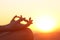 Woman hands exercising yoga at sunset