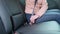 Woman hands fastening a seatbelt in the modern car. the girl in the car safety belt is strapping