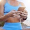 Woman hands, fitness app and phone typing outdoor in workout videos, exercise tutorial and workout music playlist