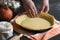 Woman hands fixing pastry dough on a tray. Home Baking. Traditional dessert preparation