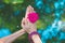 Woman hands with flower in yoga mudra gesture outdoor in nature