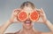 Woman, hands and fruit eyes in skincare holding grapefruit for healthy wellness against a grey studio background. Happy