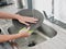 Woman with hands without gloves washes dishes with a dishwashing sponge with bubbles close-up, household chores, no