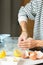 Woman hands greasing the baking dish while cooking apple pie