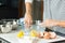 Woman hands greasing the baking dish while cooking apple pie