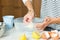 Woman hands greasing the baking dish while cooking apple pie