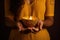 Woman hands with henna holding colorful clay diya lamps lit during diwali celebration