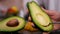 Woman hands holding an avocado - scoop out the middle