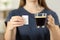 Woman hands holding a coffee cup and saccharin