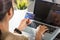 Woman hands holding credit card and using laptop with product purchase at home