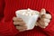 Woman hands holding a cup of hot chocolate with marshmallows.