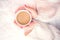 Woman hands holding a cup of hot coffee, espresso on a winter, cold day