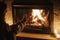 Woman hands holding cup of tea and warming up at cozy fireplace in dark evening room, close up. Fireplace heating in house,