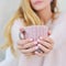 Woman hands holding decorated cup