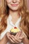 Woman hands holding a delicious yummy cupcake