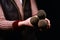 Woman hands holding dirty and dusty microphone on a dark background