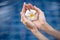 woman hands holding flower. Water Background.