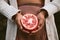 Woman hands holding fresh pomegranate in half harvested from tree. concept of eating autumn fruit for healthy diet and lifestyle