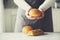 Woman hands holding freshly baked bread. Bun, cookie, bakery concept, homemade food, healthy eating. Copy space. Banner.