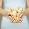 Woman hands holding ginger, sensual studio shot